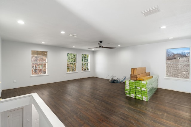 living area featuring dark hardwood / wood-style flooring and ceiling fan