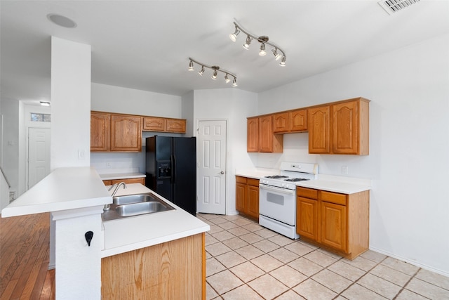 kitchen with kitchen peninsula, black fridge with ice dispenser, white range, sink, and light tile patterned flooring