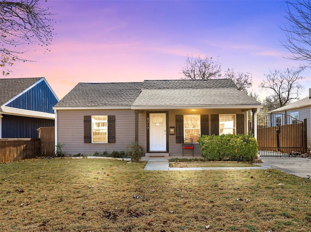 view of front of property with a lawn and a porch