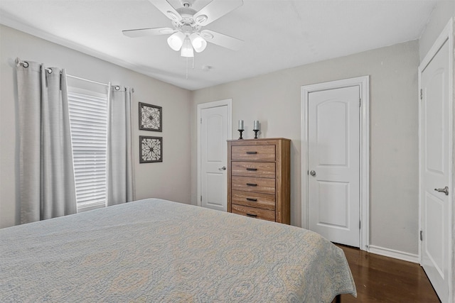 bedroom with ceiling fan and dark hardwood / wood-style flooring