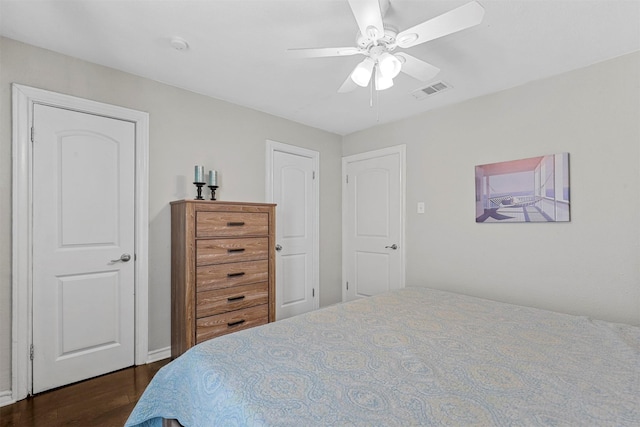 bedroom with ceiling fan and dark hardwood / wood-style flooring