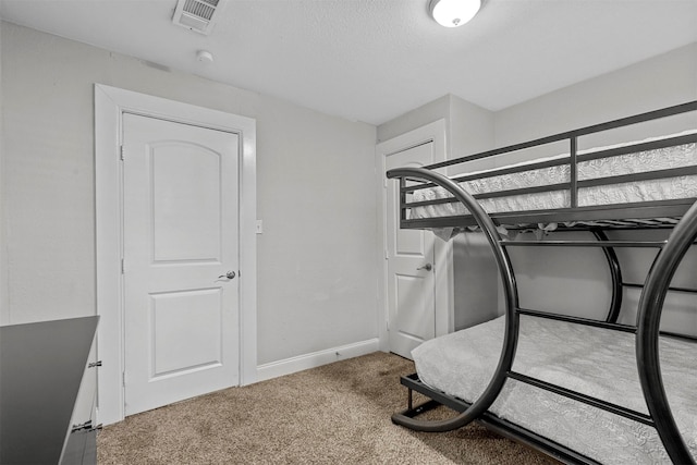 carpeted bedroom with a textured ceiling