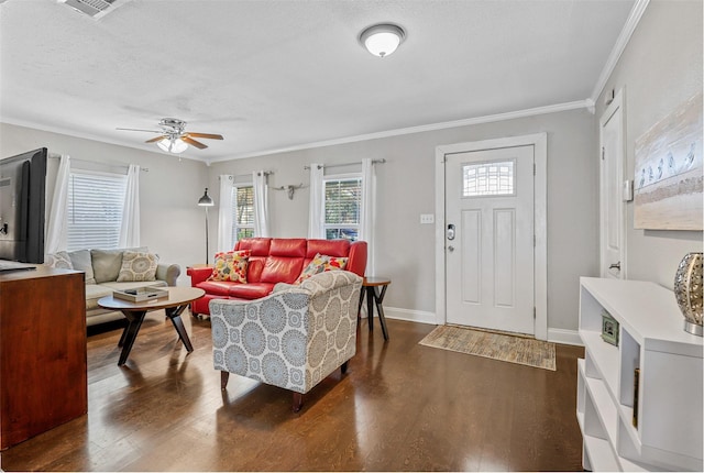 living room featuring ceiling fan, ornamental molding, dark hardwood / wood-style flooring, and a textured ceiling