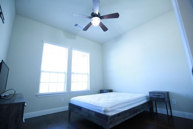 bedroom with ceiling fan and dark hardwood / wood-style floors