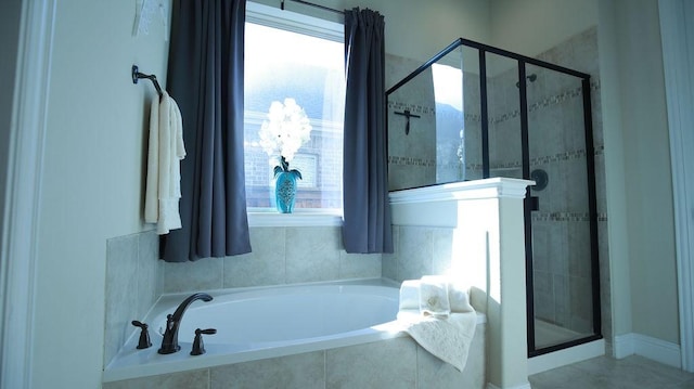 bathroom featuring a wealth of natural light and independent shower and bath