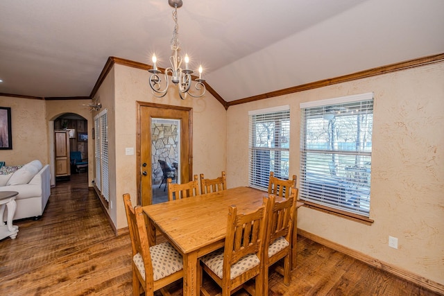 dining room featuring crown molding, vaulted ceiling, dark hardwood / wood-style floors, and a chandelier