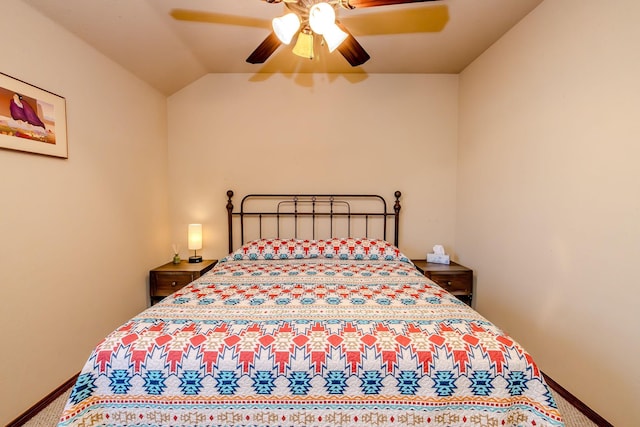 carpeted bedroom with ceiling fan and vaulted ceiling