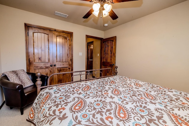 carpeted bedroom with a closet and ceiling fan