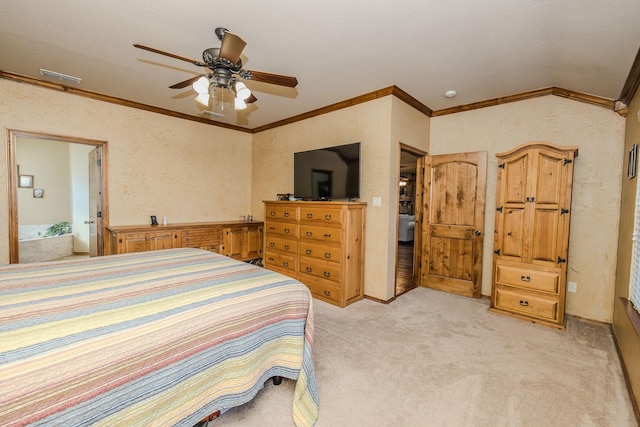 carpeted bedroom featuring ornamental molding, ensuite bathroom, and ceiling fan