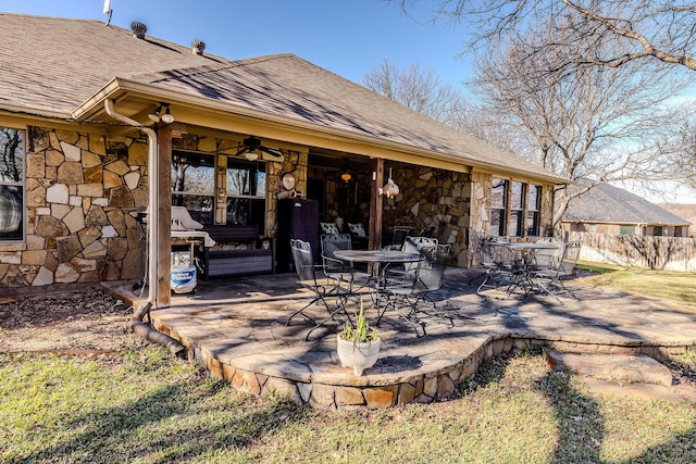 rear view of property with a patio area and ceiling fan