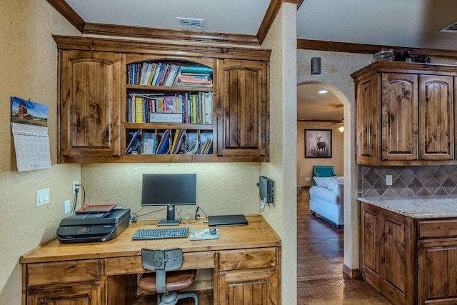 office with ornamental molding and built in desk