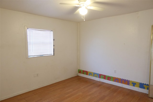 empty room with hardwood / wood-style flooring and ceiling fan