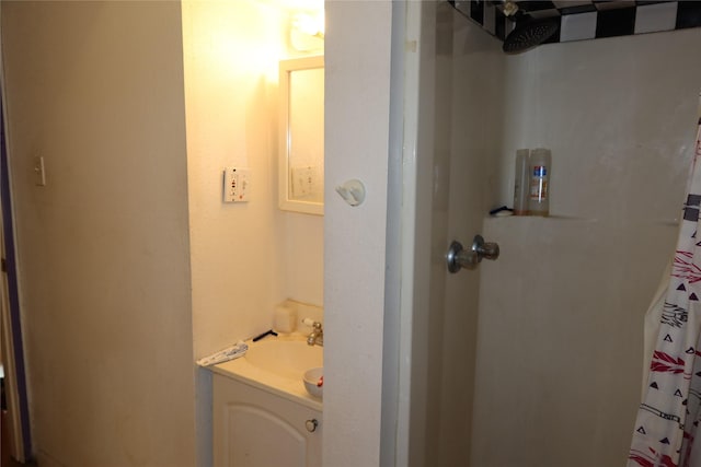 bathroom featuring vanity and a shower with shower curtain