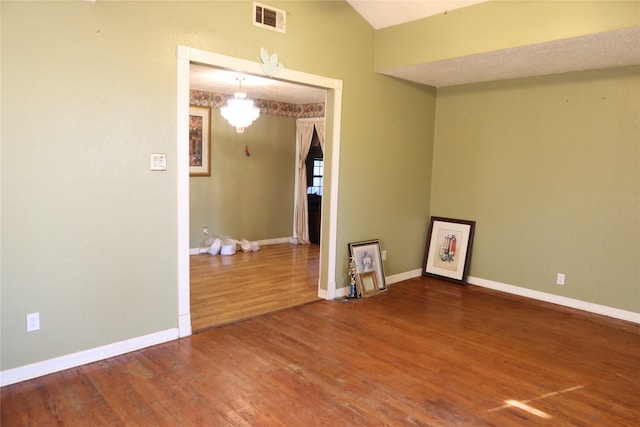 spare room with hardwood / wood-style floors