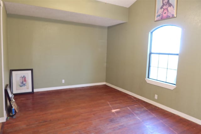 spare room with dark wood-type flooring