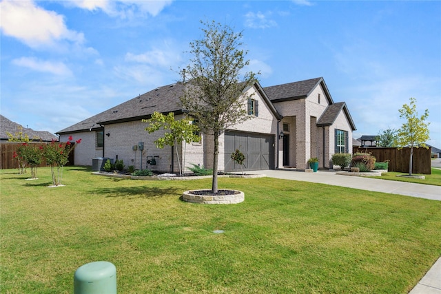 view of front facade with a garage and a front lawn