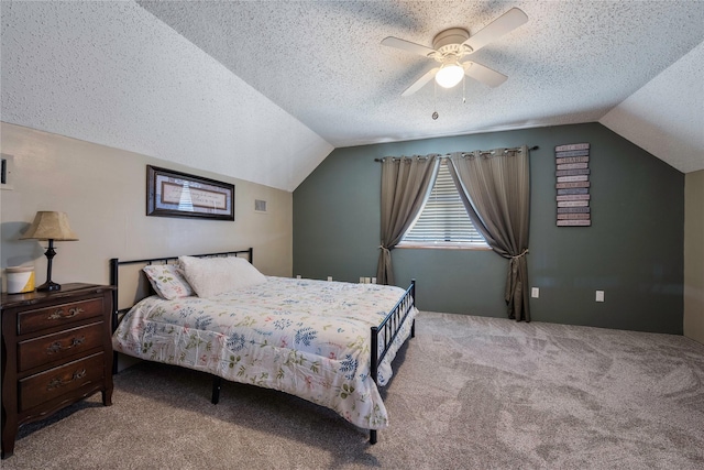 bedroom featuring a textured ceiling, ceiling fan, light colored carpet, and vaulted ceiling