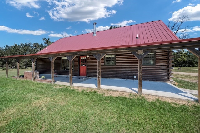 rear view of property with a yard