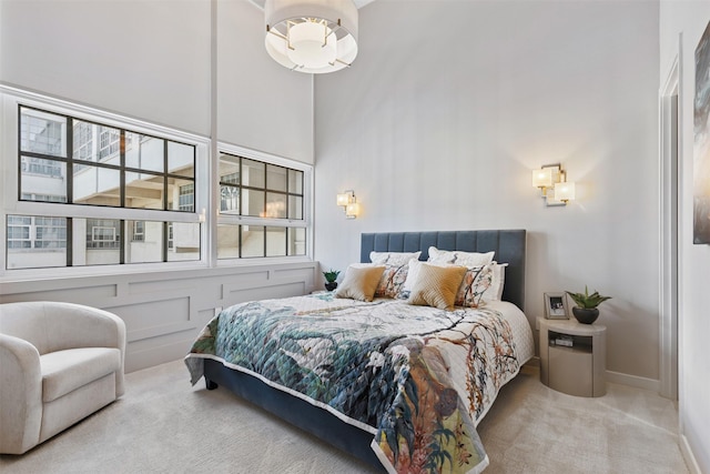 bedroom featuring carpet flooring and a high ceiling