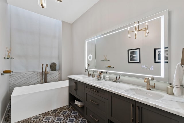 bathroom featuring vanity, tile patterned flooring, and a bathtub