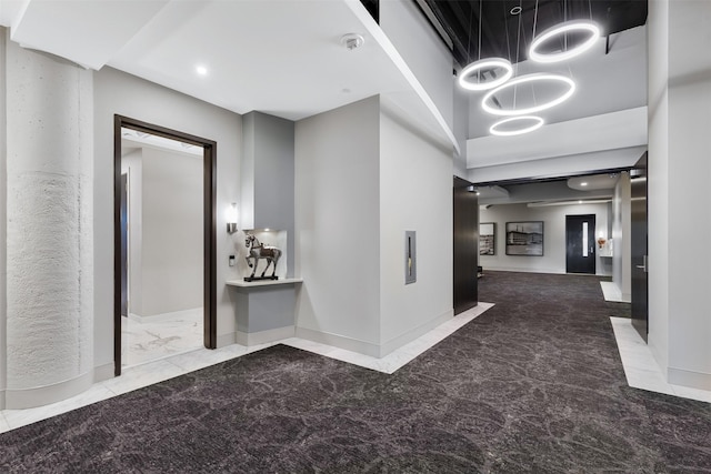 hallway featuring a high ceiling