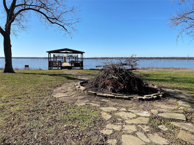 view of dock with a gazebo and a water view