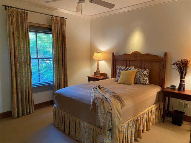 carpeted bedroom with crown molding and ceiling fan