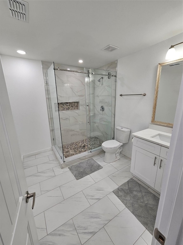 bathroom with a shower with door, vanity, and toilet