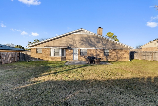 rear view of property featuring a yard