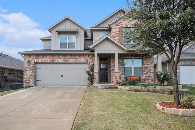 craftsman house with a front yard and a garage