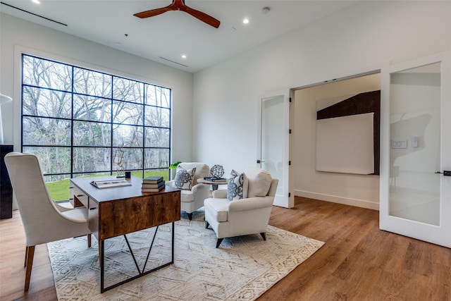 office with ceiling fan and light hardwood / wood-style floors