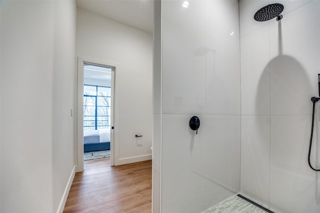 bathroom with wood-type flooring and walk in shower