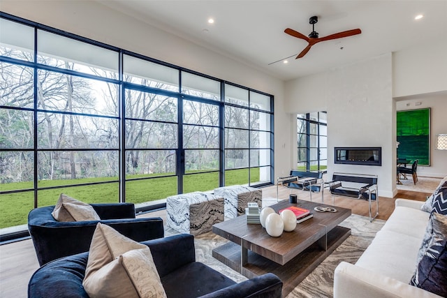 living room featuring ceiling fan and light hardwood / wood-style flooring