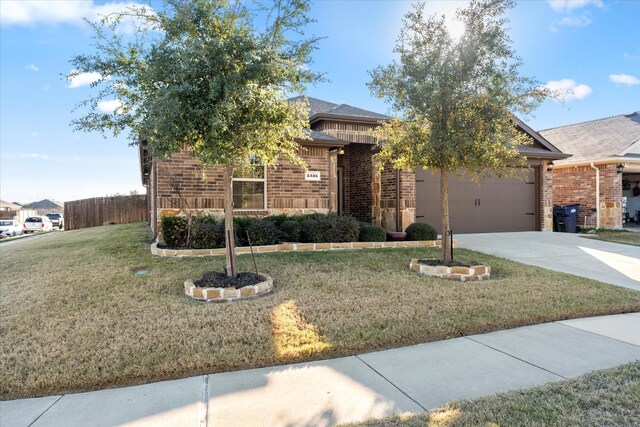 view of front of house featuring a garage and a front lawn