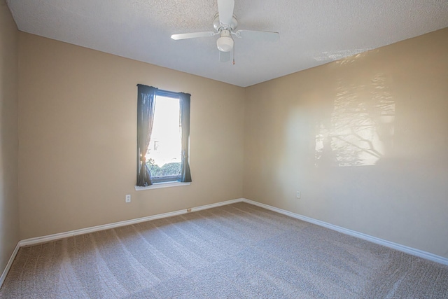 empty room featuring ceiling fan, carpet, and a textured ceiling