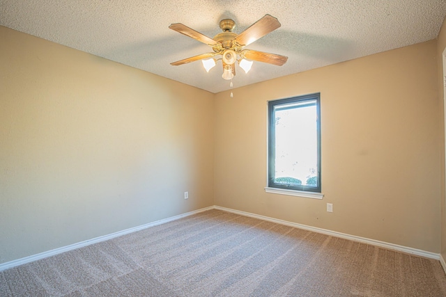 unfurnished room featuring a textured ceiling, carpet floors, and ceiling fan