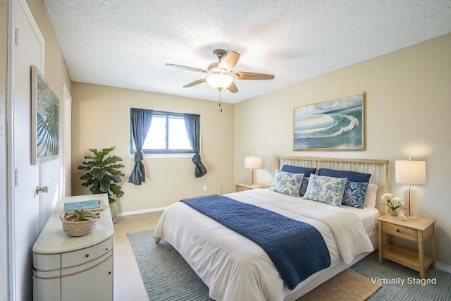 bedroom featuring ceiling fan and a textured ceiling