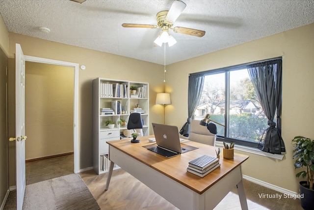 office area with ceiling fan and a textured ceiling