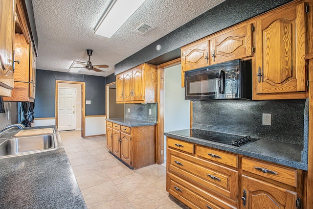 kitchen with ceiling fan, sink, backsplash, a textured ceiling, and black appliances