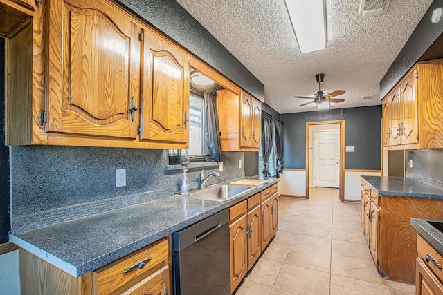 kitchen with stainless steel dishwasher, a textured ceiling, ceiling fan, sink, and light tile patterned floors