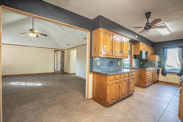 kitchen featuring decorative backsplash, a textured ceiling, vaulted ceiling, and ceiling fan