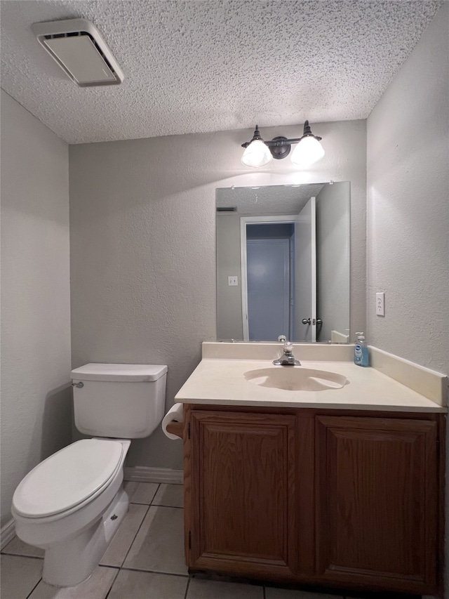 bathroom with vanity, tile patterned floors, a textured ceiling, and toilet