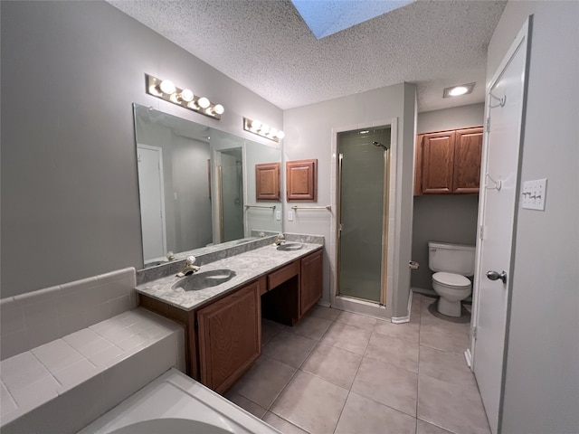 bathroom featuring a shower with door, toilet, tile patterned floors, and a skylight