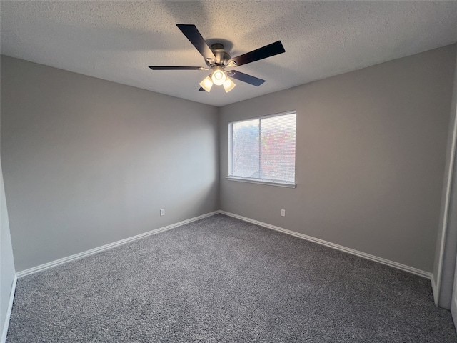 carpeted spare room featuring ceiling fan and a textured ceiling