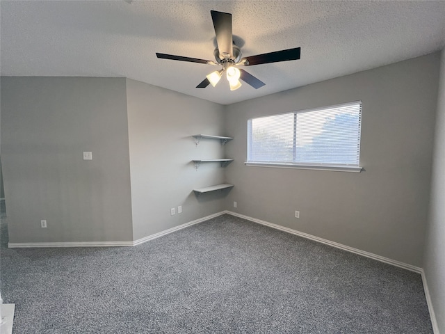 carpeted empty room featuring ceiling fan and a textured ceiling