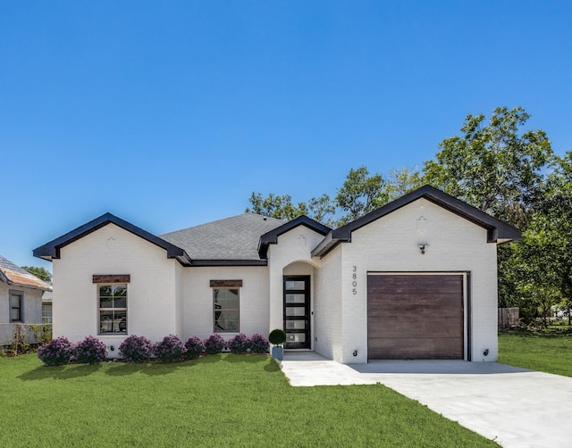 view of front of house featuring a front yard and a garage