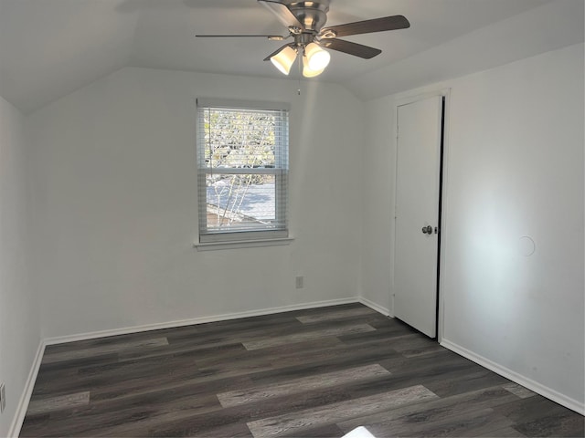 interior space with ceiling fan, dark hardwood / wood-style flooring, and vaulted ceiling