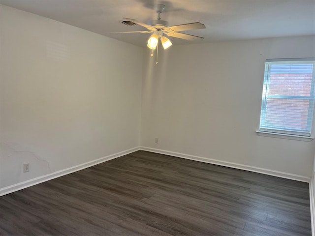 unfurnished room with ceiling fan and dark wood-type flooring