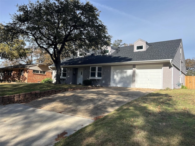 view of front of property with a front yard and a garage