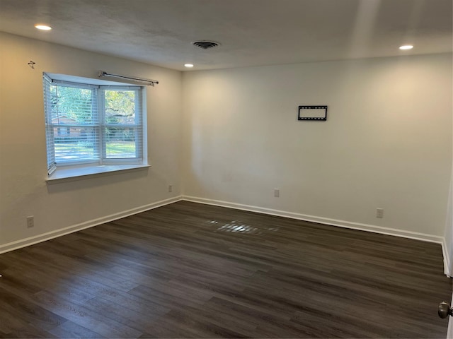 spare room with dark wood-type flooring